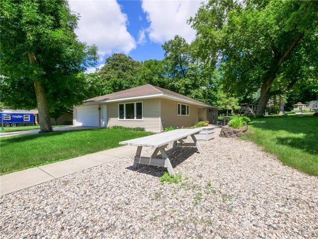 2481 Lake Miltona Dr NE Unit 1, Miltona Twp, MN 56354 - rear view of property featuring a garage and a lawn