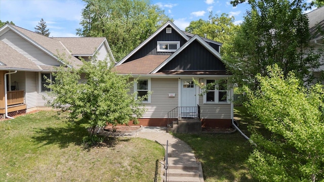 view of front facade featuring a front lawn and board and batten siding