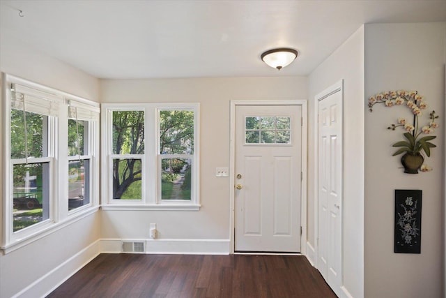 entrance foyer with dark wood finished floors and baseboards