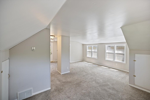 bonus room with carpet flooring, vaulted ceiling, and baseboards