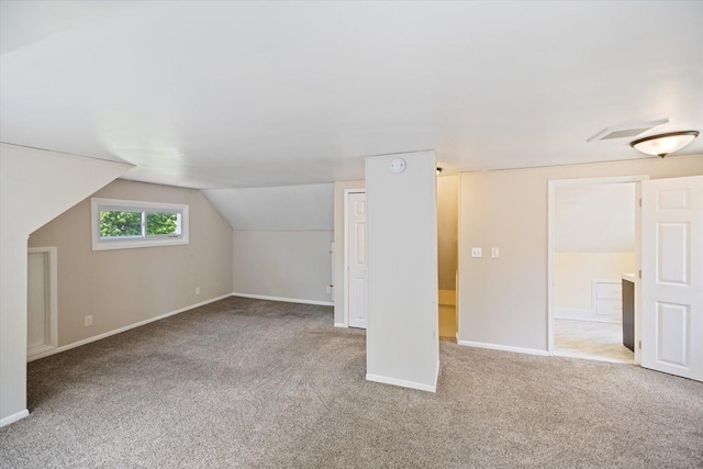 bonus room with carpet floors, baseboards, and lofted ceiling