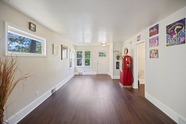 unfurnished room with dark wood-style flooring and baseboards