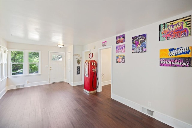 foyer featuring dark wood-style floors and baseboards