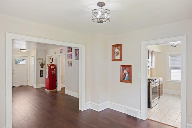 hallway featuring baseboards and wood finished floors