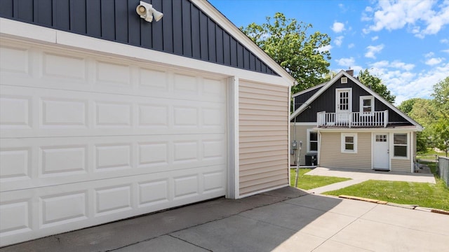garage with asphalt driveway and central air condition unit