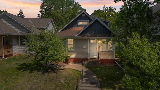 bungalow-style home featuring a front lawn and board and batten siding