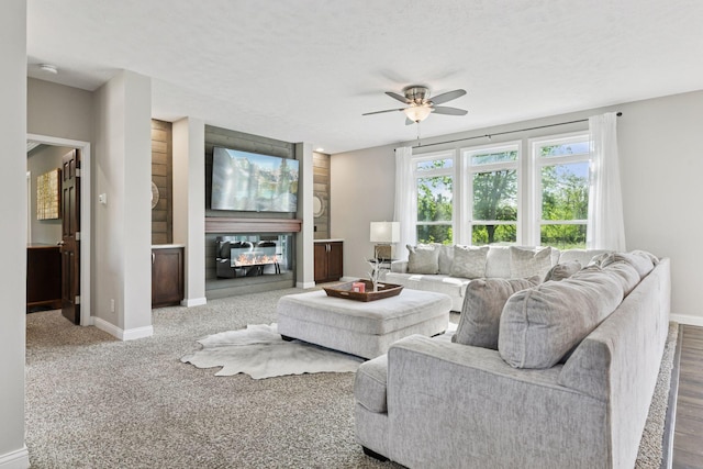 21212 Old Lake George Blvd NW, Oak Grove, MN 55303 - living room featuring ceiling fan, baseboards, and a multi sided fireplace