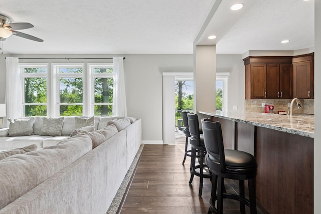 21212 Old Lake George Blvd NW, Oak Grove, MN 55303 - living room featuring healthy amount of natural light, a ceiling fan, dark wood finished floors, baseboards, and recessed lighting