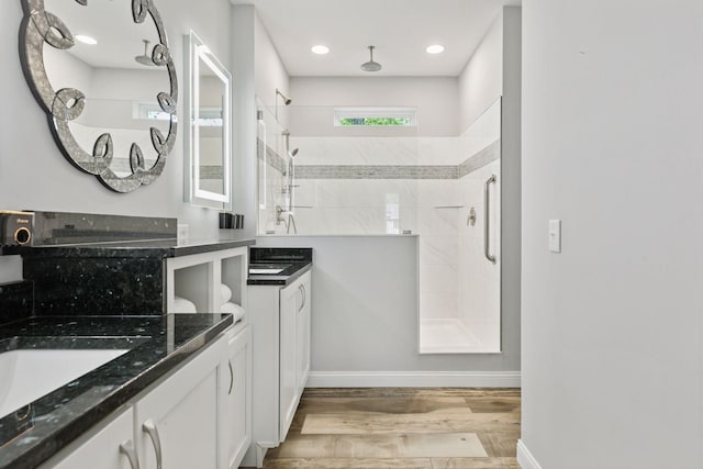 21212 Old Lake George Blvd NW, Oak Grove, MN 55303 - full bath with a shower stall, wood finished floors, two vanities, and baseboards