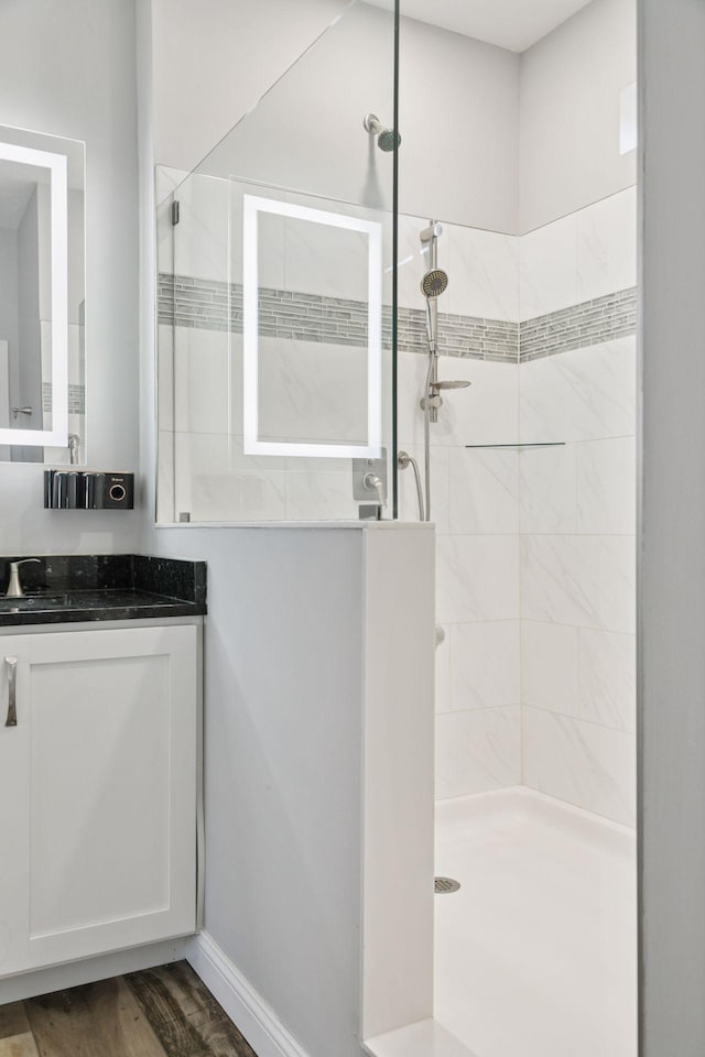 21212 Old Lake George Blvd NW, Oak Grove, MN 55303 - full bathroom featuring vanity, a walk in shower, wood finished floors, and baseboards