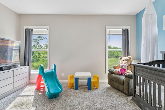 21212 Old Lake George Blvd NW, Oak Grove, MN 55303 - carpeted bedroom featuring multiple windows, baseboards, and a nursery area