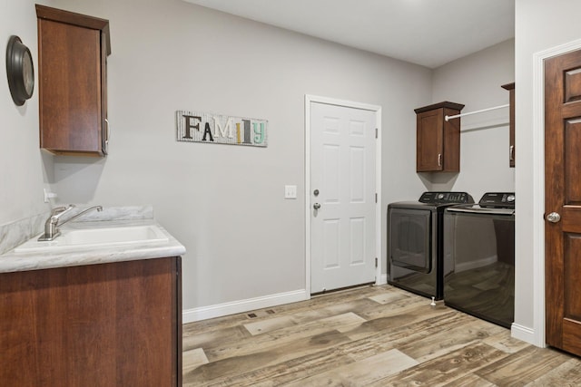21212 Old Lake George Blvd NW, Oak Grove, MN 55303 - laundry area with cabinet space, independent washer and dryer, light wood-style flooring, and baseboards
