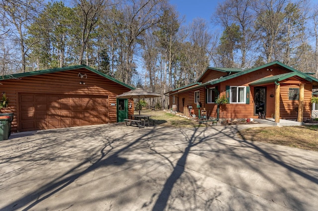 34590 Park Dr, Crosslake, MN 56442 - view of side of home featuring driveway, faux log siding, and an outbuilding