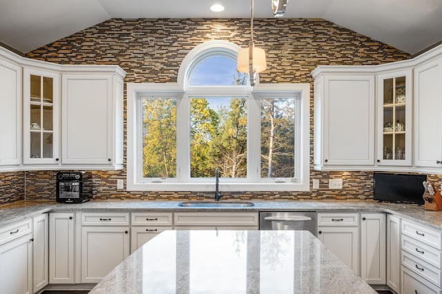 16302 Sohm Ct, Eden Prairie, MN 55347 - kitchen with a sink, lofted ceiling, tasteful backsplash, white cabinetry, and stainless steel dishwasher
