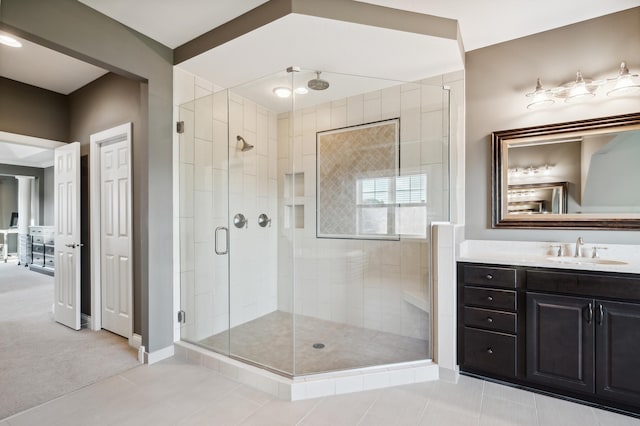 16302 Sohm Ct, Eden Prairie, MN 55347 - full bath with a stall shower, vanity, baseboards, and tile patterned flooring