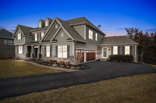 16302 Sohm Ct, Eden Prairie, MN 55347 - view of front of home featuring driveway, covered porch, an attached garage, a shingled roof, and stone siding