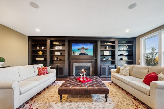 16302 Sohm Ct, Eden Prairie, MN 55347 - living area featuring built in shelves, recessed lighting, a glass covered fireplace, and wood finished floors