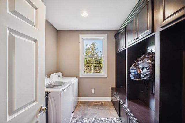 16302 Sohm Ct, Eden Prairie, MN 55347 - laundry room featuring cabinet space, washer and clothes dryer, baseboards, and stone tile floors