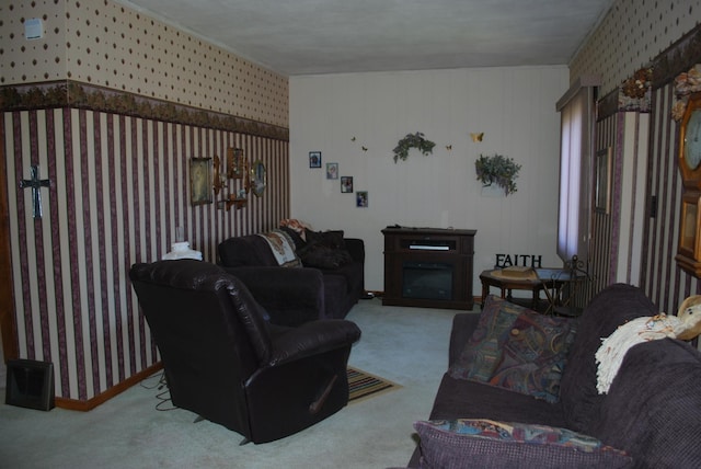 living area featuring wallpapered walls, carpet, and a glass covered fireplace