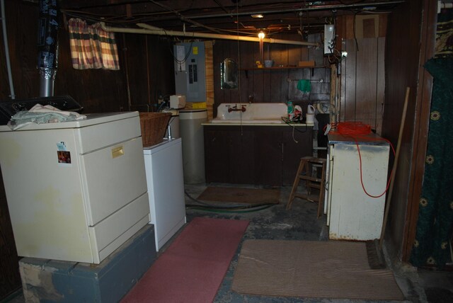 below grade area with electric panel and washer and clothes dryer