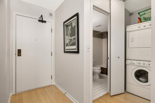 401 1st St Unit 1321, Minneapolis, MN 55401 - laundry room with stacked washing machine and dryer and light wood finished floors