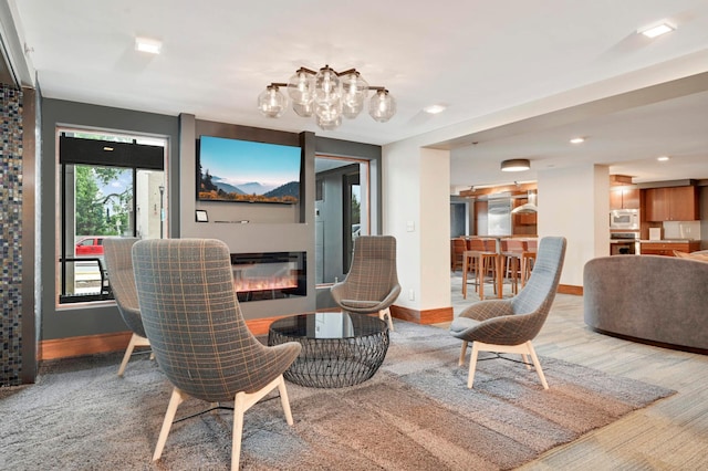 401 1st St Unit 1321, Minneapolis, MN 55401 - dining room featuring a chandelier, a glass covered fireplace, recessed lighting, and light carpet