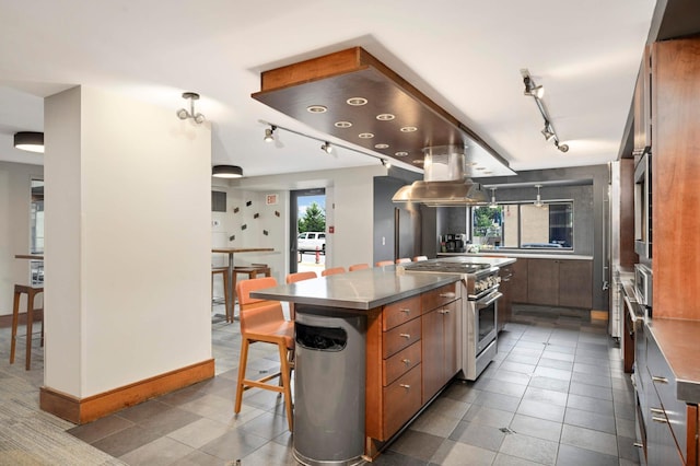 401 1st St Unit 1321, Minneapolis, MN 55401 - kitchen with appliances with stainless steel finishes, rail lighting, modern cabinets, stainless steel countertops, and a kitchen breakfast bar