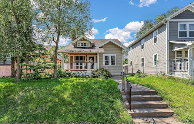 864 Fuller Ave, Saint Paul, MN 55104 - bungalow featuring a porch, a front lawn, and roof with shingles