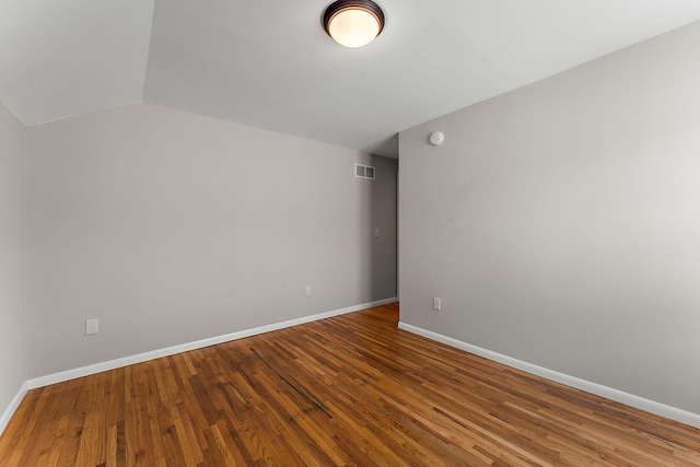 864 Fuller Ave, Saint Paul, MN 55104 - empty room featuring wood finished floors, vaulted ceiling, and a smoke detector