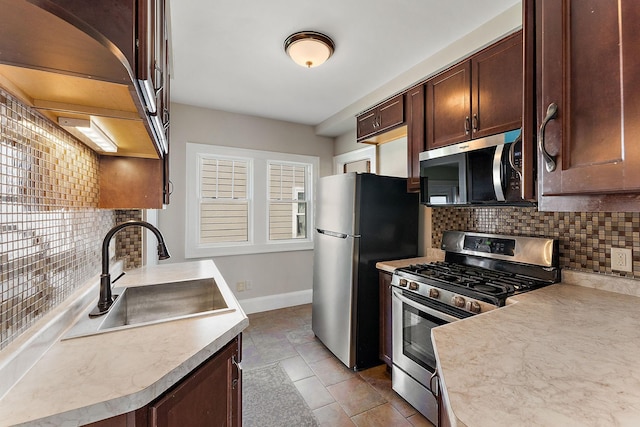 864 Fuller Ave, Saint Paul, MN 55104 - kitchen with stainless steel appliances, tasteful backsplash, light countertops, dark brown cabinetry, and tile patterned floors