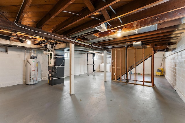 864 Fuller Ave, Saint Paul, MN 55104 - unfinished below grade area featuring gas water heater, heating unit, washer / dryer, stairs, and concrete block wall