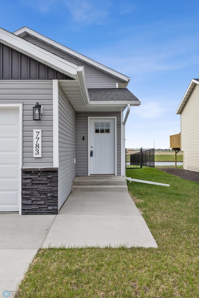 doorway to property featuring board and batten siding and stone siding
