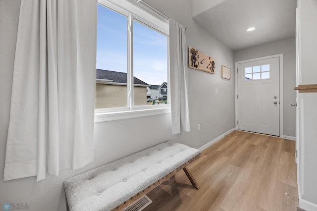 doorway with light wood-style flooring, baseboards, and recessed lighting