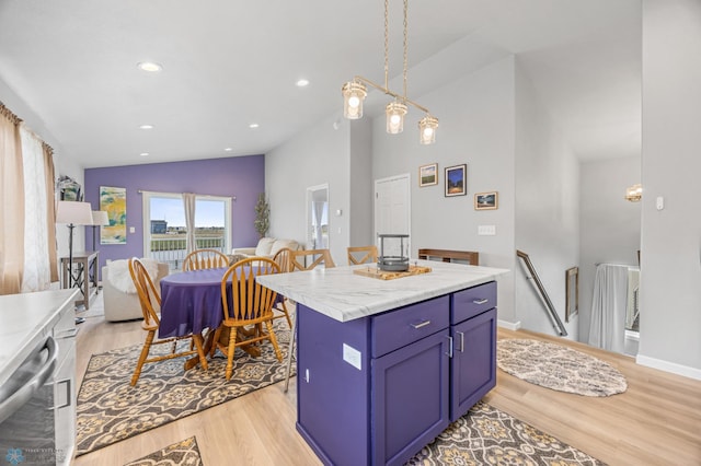 kitchen featuring vaulted ceiling, light wood-style floors, light countertops, a center island, and blue cabinetry