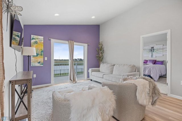 living area with baseboards, vaulted ceiling, wood finished floors, and recessed lighting