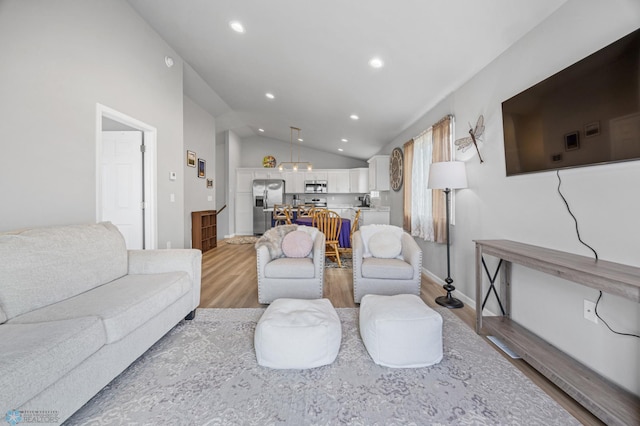 living area with light wood finished floors, lofted ceiling, recessed lighting, and baseboards