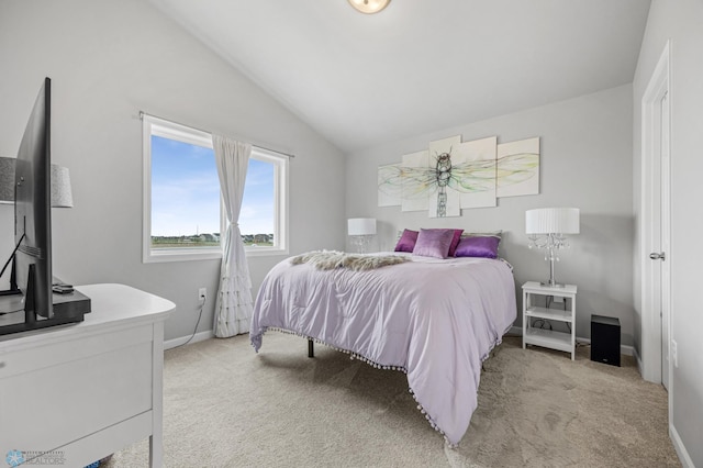 bedroom with lofted ceiling, light carpet, and baseboards