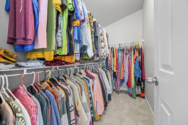 spacious closet with carpet and vaulted ceiling