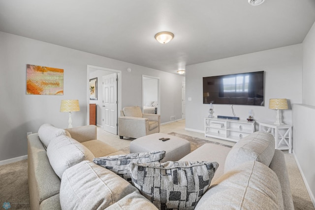 carpeted living area featuring baseboards