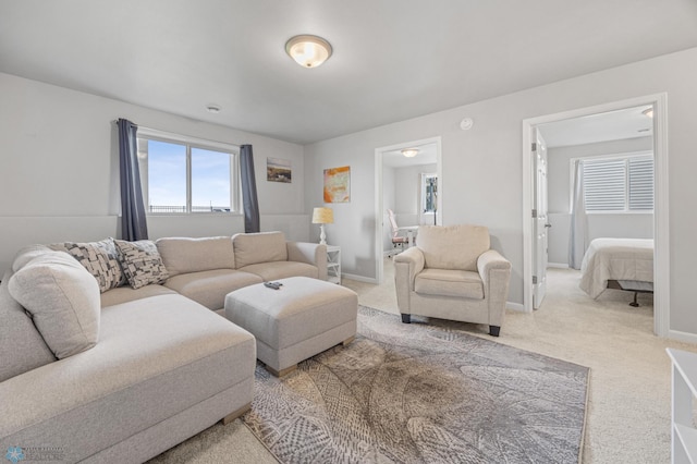 living area featuring carpet and baseboards
