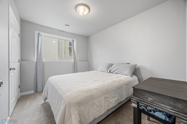 carpeted bedroom featuring baseboards