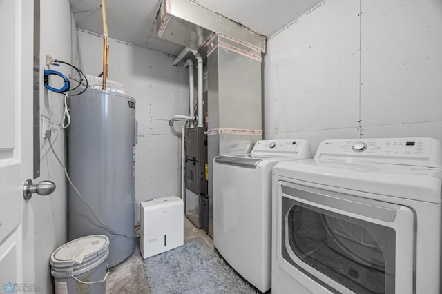 laundry area featuring water heater and washing machine and dryer