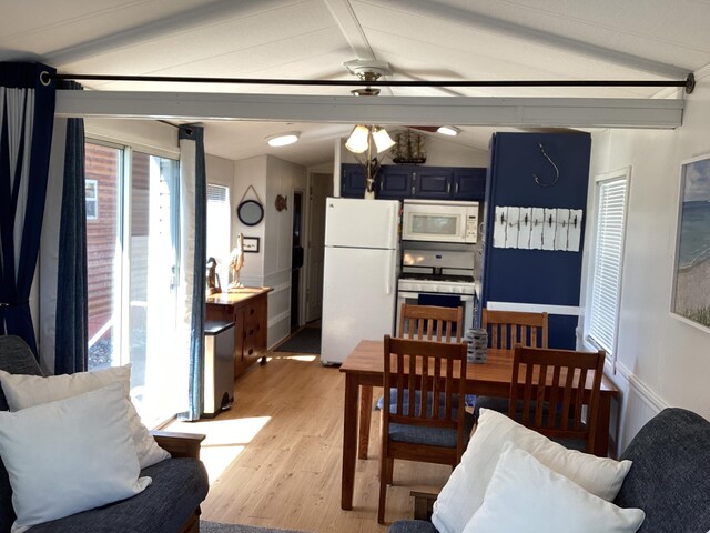 dining space with light wood-type flooring, plenty of natural light, and a ceiling fan