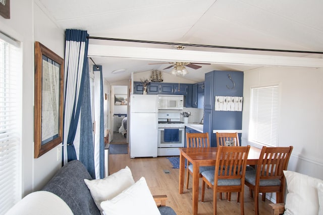 dining space featuring lofted ceiling, light wood-type flooring, and a ceiling fan