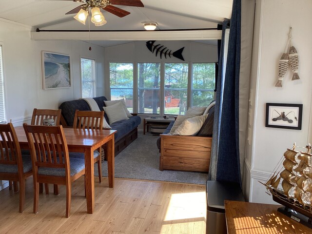 dining space with light wood-style flooring and a ceiling fan