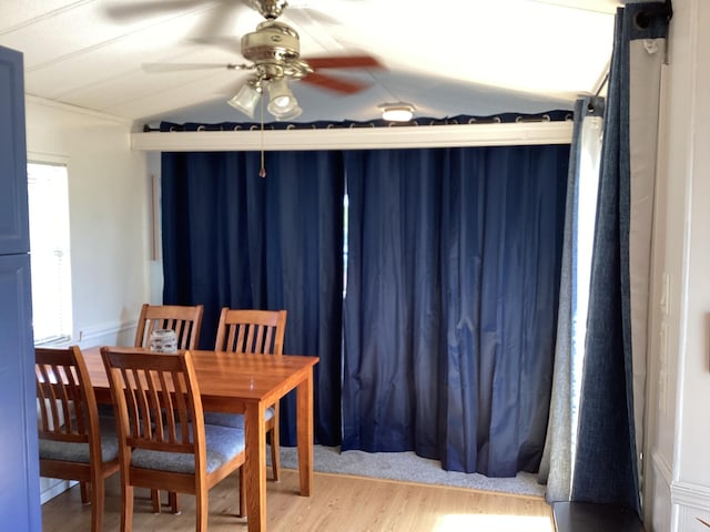 dining area featuring vaulted ceiling, wood finished floors, and ceiling fan