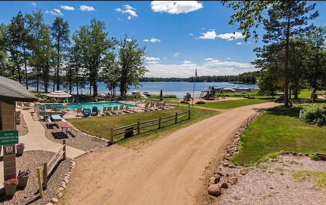 view of community with a water view and a lawn