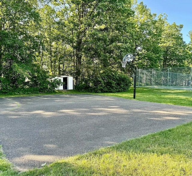 view of basketball court featuring a shed