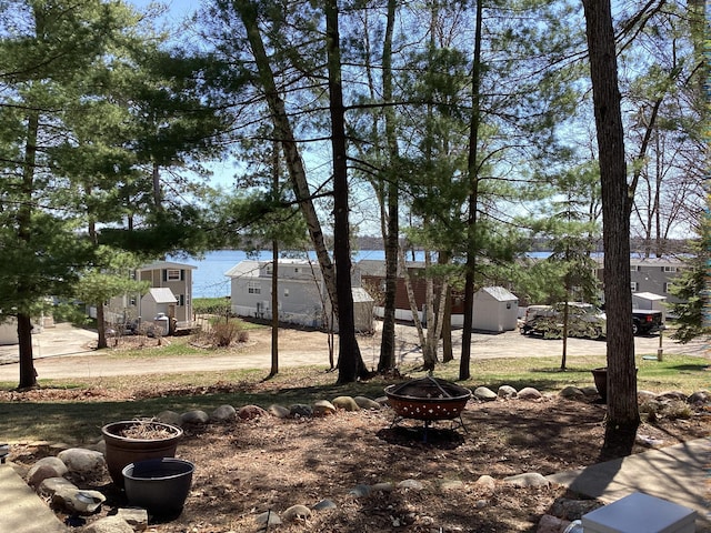 15827 Wilderness Trl, Crosslake, MN 56442 - view of yard featuring a fire pit, a shed, and an outdoor structure
