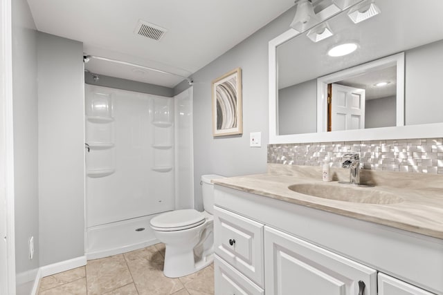 1900 Vernon Dr S, Minnetonka, MN 55305 - bathroom with vanity, toilet, a shower, tasteful backsplash, and tile patterned floors
